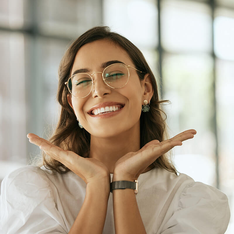Happy Woman with Glasses Showing off her Smile