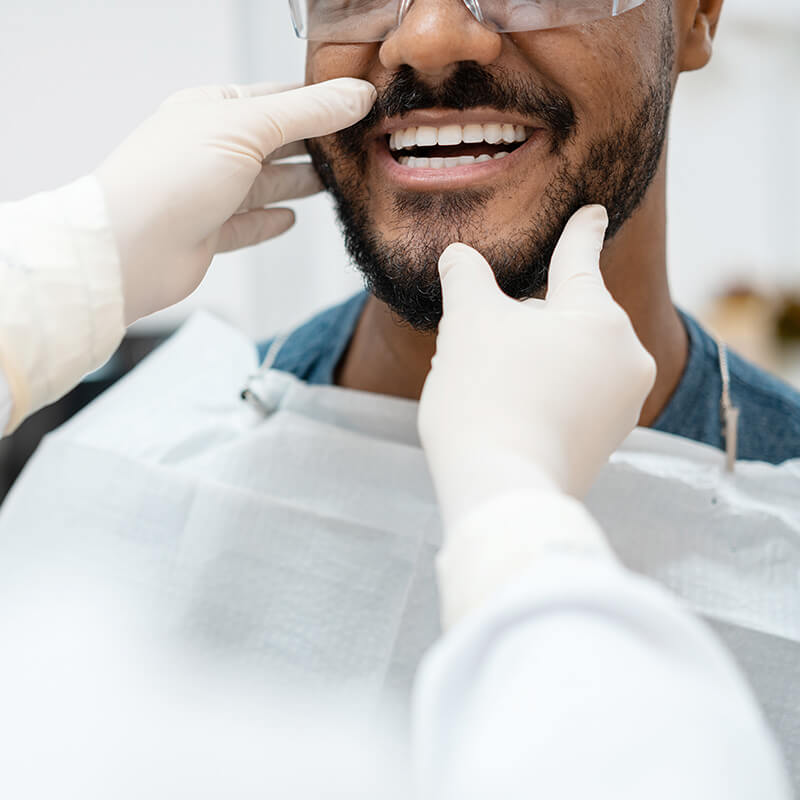 Man Getting his Mouth Examined by Dentist