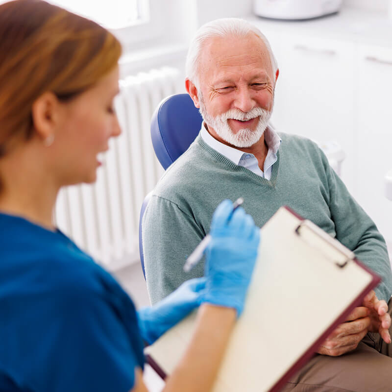 Elderly Man being Examined by Dentist