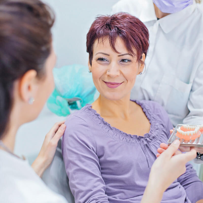 Dentist Showing Teeth Options to Patient