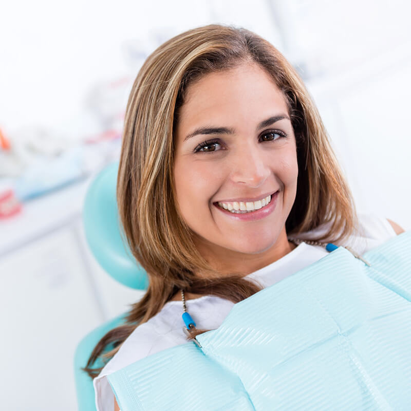 Woman Smiling in Dental Office Chair