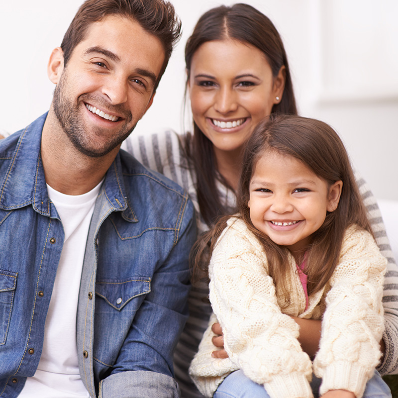 Father, Daughter and Mother sitting on Stoop and Smiling